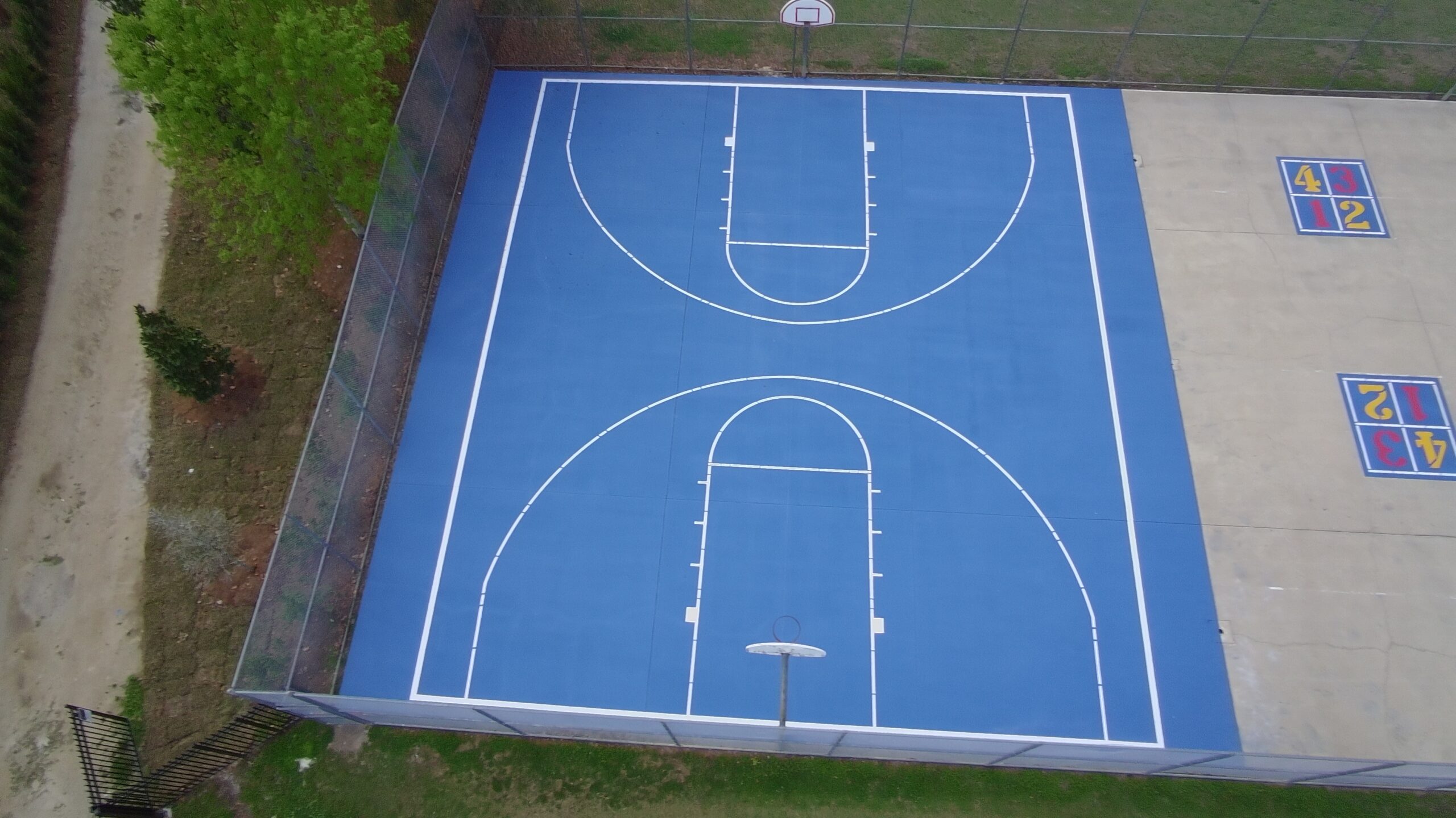 Aerial view of completed blue basketball court painting
