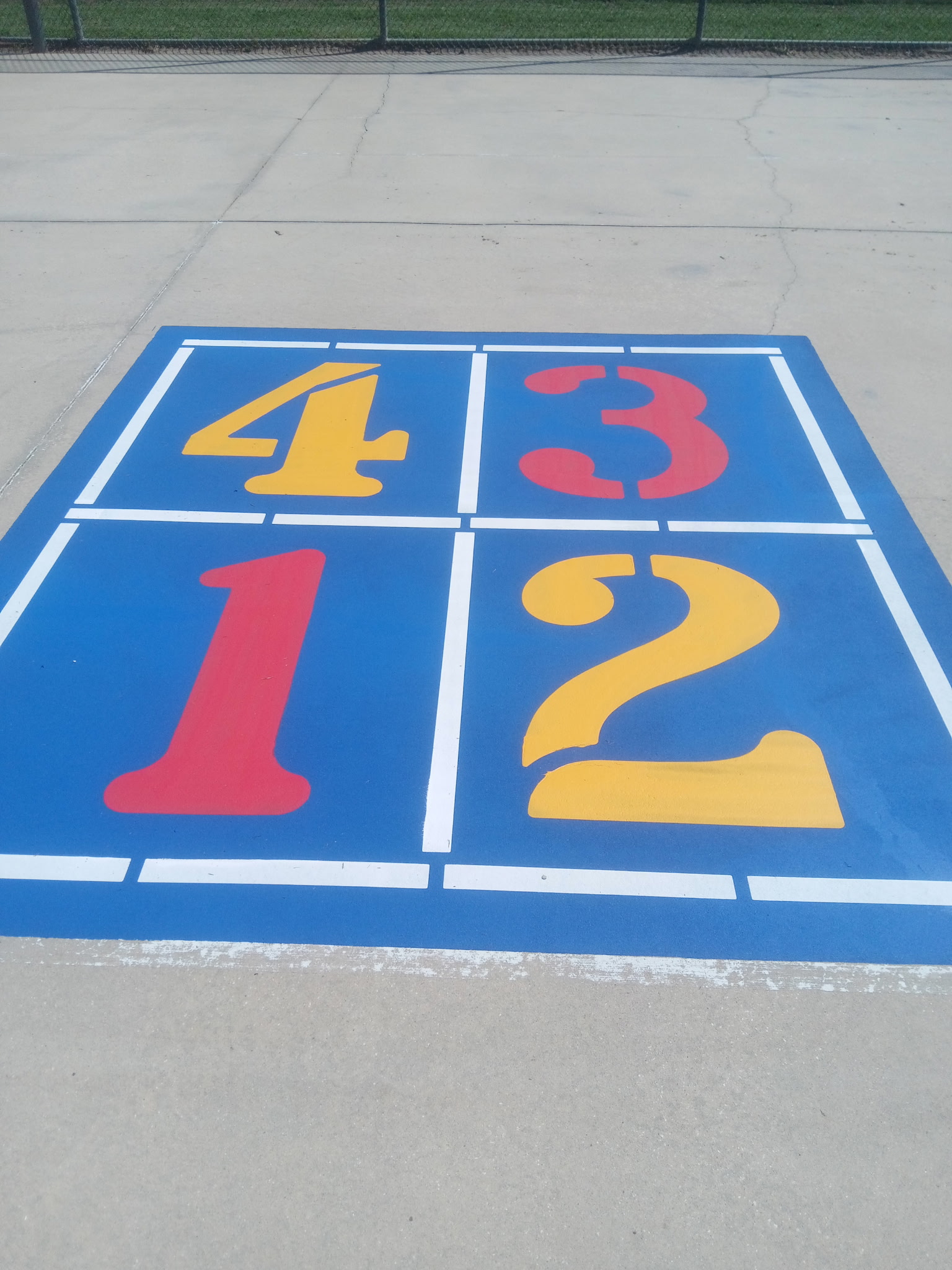 Custom painted four-square game court with colorful numbers